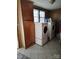 Laundry room featuring a washer, dryer, storage cabinet, and tile floors at 2508 S Main St # 68, Concord, NC 28027