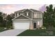 Charming two-story home featuring a two-car garage, neutral colors, and a welcoming front porch at 286 Bezelle Ave, York, SC 29745