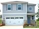 Charming two-story home with gray siding, gray shutters, a brick base, and a two-car garage at 290 Bezelle Ave, York, SC 29745