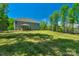 Spacious backyard, perfect for outdoor activities, with well-maintained lawn and mature trees at 3011 Waxhaw Crossing Dr, Waxhaw, NC 28173