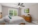 Cozy bedroom featuring a ceiling fan, natural light, and classic wood furniture at 3011 Waxhaw Crossing Dr, Waxhaw, NC 28173