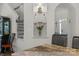 Butler's pantry leads to dining area with clear glass shelving and decorative accessories at 3011 Waxhaw Crossing Dr, Waxhaw, NC 28173