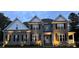 Charming two-story brick home featuring a welcoming front porch and tasteful landscaping with blooming flowers at 3011 Waxhaw Crossing Dr, Waxhaw, NC 28173