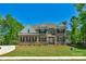 Beautiful two-story brick home with manicured lawn, black shutters, and a welcoming front porch at 3011 Waxhaw Crossing Dr, Waxhaw, NC 28173