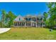 Beautiful two-story brick home with manicured lawn, black shutters, and a welcoming front porch at 3011 Waxhaw Crossing Dr, Waxhaw, NC 28173