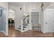 Entryway with hardwood floors, staircase, arched doorways, and a decorative bench at 3011 Waxhaw Crossing Dr, Waxhaw, NC 28173