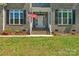 Home's entryway with American flag, brick stairs and black shuttered windows at 3011 Waxhaw Crossing Dr, Waxhaw, NC 28173