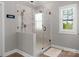 Tiled walk-in shower with glass door and window providing natural light, and wood-look floors at 3011 Waxhaw Crossing Dr, Waxhaw, NC 28173