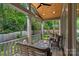 Covered back porch with a seating area and view of the backyard at 3228 E Ford Rd, Charlotte, NC 28205