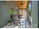 Covered back porch with a ceiling fan, wood ceiling, and comfortable seating area at 3228 E Ford Rd, Charlotte, NC 28205