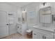 Bright bathroom featuring double sink vanities, framed mirrors and natural light from the plantation shuttered window at 3228 E Ford Rd, Charlotte, NC 28205