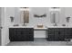 Modern bathroom featuring dual vanities with sleek black cabinetry and a unique central makeup area at 3228 E Ford Rd, Charlotte, NC 28205