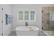 Elegant bathroom features a freestanding tub and separate glass enclosed shower with seamless design at 3228 E Ford Rd, Charlotte, NC 28205
