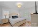 Bedroom with a queen bed, matching nightstands, hardwood floors and plantation shutters on the windows at 3228 E Ford Rd, Charlotte, NC 28205