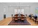 Formal dining room featuring hardwood floors, decorative rug, and an elegant chandelier at 3228 E Ford Rd, Charlotte, NC 28205
