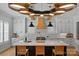 Bright kitchen featuring a large center island, white cabinetry, and modern pendant lighting at 3228 E Ford Rd, Charlotte, NC 28205