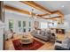 Bright living room featuring hardwood floors, exposed wood beams, and a stylish chandelier at 3228 E Ford Rd, Charlotte, NC 28205