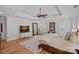 This primary bedroom offers hardwood floors, tray ceiling, a large bed and an elegant color scheme at 3228 E Ford Rd, Charlotte, NC 28205