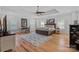 Spacious primary bedroom features tray ceiling, hardwood floors, a large bed and an elegant color scheme at 3228 E Ford Rd, Charlotte, NC 28205