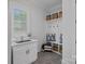 Bright mudroom with white cabinets, a sink, bench seating, and plenty of storage at 3228 E Ford Rd, Charlotte, NC 28205