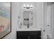 Modern powder room with a dark vanity, marble countertop, and decorative lighting at 3228 E Ford Rd, Charlotte, NC 28205