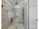 Luxurious tiled shower with rainfall shower head and glass enclosure; a perfect blend of style and comfort at 3228 E Ford Rd, Charlotte, NC 28205