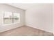 This bedroom features neutral walls, carpet flooring, and a bright window providing natural light at 3330 Strong Box Ln, Gastonia, NC 28052