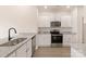 Modern kitchen featuring stainless steel appliances, granite countertops, and white cabinets at 3330 Strong Box Ln, Gastonia, NC 28052