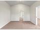 Spacious bedroom with vaulted ceiling, plush carpet, and open doorway leading to the rest of the home at 3435 Saddlebred Dr, Gastonia, NC 28052