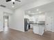 Bright kitchen featuring white cabinets, stainless steel appliances, a granite island, and light wood flooring at 3435 Saddlebred Dr, Gastonia, NC 28052