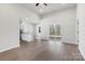 Open-concept living space showcasing light wood floors, a sliding glass door, and a view of the kitchen at 3435 Saddlebred Dr, Gastonia, NC 28052