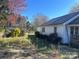 View of the backyard showing the home's exterior, green grass, storage building, and back porch at 3603 Nc 90 E Hwy, Taylorsville, NC 28681