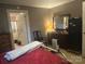 Bedroom with neutral colors, dresser with mirror, and connected bath at 3603 Nc 90 E Hwy, Taylorsville, NC 28681