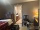 Cozy bedroom features neutral paint and furniture, adjoins an en suite bathroom at 3603 Nc 90 E Hwy, Taylorsville, NC 28681