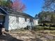 This angle of the home shows off it's simple design and the backyard with a carport and storage at 3603 Nc 90 E Hwy, Taylorsville, NC 28681