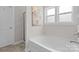 Bright bathroom featuring a soaking tub, tiled floors, and a separate shower at 367 Neely Store Rd, Rock Hill, SC 29730