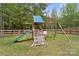 Wooden playset in backyard with slide, climbing wall, swings, and seating at 367 Neely Store Rd, Rock Hill, SC 29730