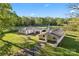 Aerial view of the home and adjacent church and pond on a sprawling lot at 36984 B&C Carter Rd, New London, NC 28127