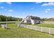 White barn with a fenced-in perimeter, exterior stairs, and balcony at 36984 B&C Carter Rd, New London, NC 28127
