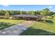Charming brick home featuring a metal roof, covered carport, and well-manicured lawn at 36984 B&C Carter Rd, New London, NC 28127