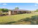 Beautiful brick home with a metal roof, covered carport, and lush green lawn at 36984 B&C Carter Rd, New London, NC 28127