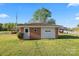 Detached one-car garage with brick exterior, features a roll-up door and adjacent doorway at 36984 B&C Carter Rd, New London, NC 28127