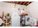 Functional laundry room with washer, dryer, and shelving at 36984 B&C Carter Rd, New London, NC 28127