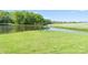 Private pond with a wooden arch, surrounded by well-maintained grassy fields at 36984 B&C Carter Rd, New London, NC 28127