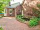 A lovely backyard with a brick patio, lush landscaping and a small pond at 3815 Glen Haven Sw Dr, Concord, NC 28027