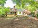 A brick home with a covered hot tub and a backyard with a swing set at 3815 Glen Haven Sw Dr, Concord, NC 28027