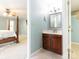 Bathroom featuring a vanity sink next to a bedroom with a four poster bed at 3815 Glen Haven Sw Dr, Concord, NC 28027