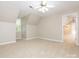 A vacant bedroom with a window, ceiling fan, carpet and neutral colored walls at 3815 Glen Haven Sw Dr, Concord, NC 28027