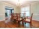 Elegant dining room with hardwood floors, chandelier lighting, and decorative wall molding at 3815 Glen Haven Sw Dr, Concord, NC 28027
