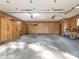 Spacious garage interior with paneled walls, overhead lighting, and ample storage and workspace at 3815 Glen Haven Sw Dr, Concord, NC 28027